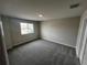 Bright, carpeted bedroom with a large window for natural light and an adjacent closet at 5084 Rain Shadow Dr, Saint Cloud, FL 34772