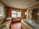 Bathroom with a sunken tub, dual sinks and a window at 545 Margaret Ct, Orlando, FL 32801