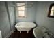 Bathroom featuring a claw foot tub, sink and a window at 545 Margaret Ct, Orlando, FL 32801