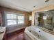 Bathroom featuring a tub and a separate walk-in shower at 545 Margaret Ct, Orlando, FL 32801