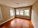 Bedroom featuring three windows and wooden floors at 545 Margaret Ct, Orlando, FL 32801