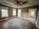 Bedroom with hardwood floors, windows, ceiling fan, and doorway to an adjacent room at 545 Margaret Ct, Orlando, FL 32801