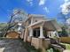 Classic home featuring a covered porch with decorative columns and an adjacent garage, showcasing the property's features at 545 Margaret Ct, Orlando, FL 32801