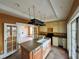 Kitchen with an island, hanging pot rack, stainless steel appliances and white cabinets at 545 Margaret Ct, Orlando, FL 32801