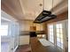 Traditional kitchen with white cabinets, dark countertops, and a unique hanging pot rack at 545 Margaret Ct, Orlando, FL 32801