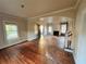 Open living room featuring wood floors, fireplace, and architectural archways to other rooms at 545 Margaret Ct, Orlando, FL 32801