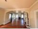 Open-concept living room with hardwood floors and arched entryway at 545 Margaret Ct, Orlando, FL 32801