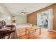 Spacious living room featuring wood flooring, tile area, ceiling fan, and sliding glass doors to the backyard at 8626 Baylor Cir, Orlando, FL 32817