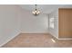 Bright dining room with a chandelier, neutral walls, and large tile flooring at 2847 Metro Sevilla Dr # 105, Orlando, FL 32835