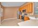 Well-lit kitchen featuring stainless steel appliances and tile flooring with ample counterspace at 2847 Metro Sevilla Dr # 105, Orlando, FL 32835