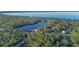 Beautiful aerial view of a serene lake surrounded by lush trees and a scattering of houses at 360 Rest Haven Rd, Geneva, FL 32732