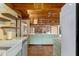 The kitchen has painted cabinets, exposed-beam ceilings and an integrated sink at 360 Rest Haven Rd, Geneva, FL 32732