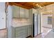 Charming kitchen with painted cabinets, stone backsplash and stainless steel appliances at 360 Rest Haven Rd, Geneva, FL 32732