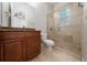 Bright bathroom featuring tiled shower, decorative glass and granite vanity top at 7508 Lake Albert Dr, Windermere, FL 34786