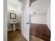 The bathroom features a pedestal sink and views of the living area at 7508 Lake Albert Dr, Windermere, FL 34786
