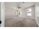 Spacious bedroom with carpet, natural light from two windows, and ceiling fan at 7508 Lake Albert Dr, Windermere, FL 34786