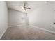 Expansive bedroom featuring carpet flooring, a ceiling fan, and a large window at 7508 Lake Albert Dr, Windermere, FL 34786