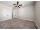 Bedroom featuring a ceiling fan, neutral paint, carpeting, and closets at 7508 Lake Albert Dr, Windermere, FL 34786