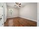 This bedroom features hardwood floors, a ceiling fan, and a window view at 7508 Lake Albert Dr, Windermere, FL 34786