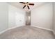 Carpeted bedroom with double-door closet and a ceiling fan at 7508 Lake Albert Dr, Windermere, FL 34786