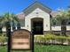 Lake Burden clubhouse at the Lakes of Windermere offers a welcoming entrance with mature landscaping at 7508 Lake Albert Dr, Windermere, FL 34786