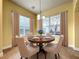 Cozy dining room features natural light, a classic chandelier, and elegant furniture at 7508 Lake Albert Dr, Windermere, FL 34786