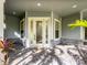 Covered front entry with decorative glass door, stone accents and brick paver porch at 7508 Lake Albert Dr, Windermere, FL 34786
