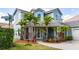 Charming two-story home with a welcoming front porch and lush landscaping at 7508 Lake Albert Dr, Windermere, FL 34786