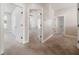 Hallway with multiple doors and neutral carpet leading to various rooms at 7508 Lake Albert Dr, Windermere, FL 34786