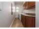 Laundry room featuring storage cabinets and granite countertops, washer, and dryer at 7508 Lake Albert Dr, Windermere, FL 34786
