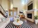 Bright living room boasts high ceilings, fireplace, modern furniture, and lots of natural light at 7508 Lake Albert Dr, Windermere, FL 34786