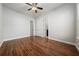 Primary bedroom features hardwood floors, a ceiling fan, and two doors at 7508 Lake Albert Dr, Windermere, FL 34786