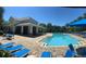 Community pool area with a zero entry pool, lounge chairs, and covered seating for residents at 7508 Lake Albert Dr, Windermere, FL 34786