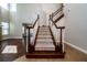 Carpeted staircase with wooden banisters in a bright, two-story foyer setting at 7508 Lake Albert Dr, Windermere, FL 34786
