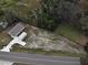 Aerial view showcasing the home, metal garage, driveway, and the surrounding landscape at 9650 Nw Gainesville Rd, Ocala, FL 34475