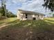 Home exterior with a backyard including the green lawn and exterior wall at 9650 Nw Gainesville Rd, Ocala, FL 34475