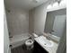 Bright bathroom featuring a tub and shower combination with tile surround and a granite vanity at 9650 Nw Gainesville Rd, Ocala, FL 34475