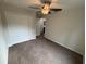 Cozy bedroom with neutral carpet, ceiling fan, and closet offers comfort and storage at 9650 Nw Gainesville Rd, Ocala, FL 34475