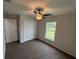 Bedroom with carpet, ceiling fan, closet, and a window with a view of the yard at 9650 Nw Gainesville Rd, Ocala, FL 34475