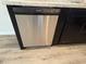 Stainless steel dishwasher seamlessly integrated into the dark cabinetry, promising modern convenience at 9650 Nw Gainesville Rd, Ocala, FL 34475