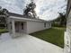 Side view of a home featuring a covered porch and a well-maintained lawn at 9650 Nw Gainesville Rd, Ocala, FL 34475