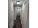 Well-lit hallway featuring neutral colors and wood flooring at 9650 Nw Gainesville Rd, Ocala, FL 34475