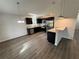 Modern kitchen with stainless steel appliances, dark cabinets, and an open layout with great natural light at 9650 Nw Gainesville Rd, Ocala, FL 34475