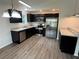 Modern kitchen featuring stainless steel appliances, sleek dark cabinetry, and stylish countertops at 9650 Nw Gainesville Rd, Ocala, FL 34475