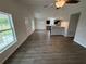Open-concept living room with wood floors and stainless steel appliances at 9650 Nw Gainesville Rd, Ocala, FL 34475