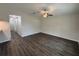 Spacious living room featuring wood floors and a ceiling fan at 9650 Nw Gainesville Rd, Ocala, FL 34475