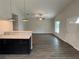 Open-concept living room with modern flooring, ceiling fan, and seamless transition to the kitchen at 9650 Nw Gainesville Rd, Ocala, FL 34475