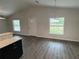 Bright living room with wood floors, large windows, and an eat-in kitchen bar at 9650 Nw Gainesville Rd, Ocala, FL 34475