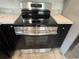 Close-up of a stainless steel oven with a black stovetop, complemented by elegant countertops at 9650 Nw Gainesville Rd, Ocala, FL 34475