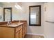 Double vanity bathroom with granite countertop and large mirror at 110 Surf St, New Smyrna Beach, FL 32169